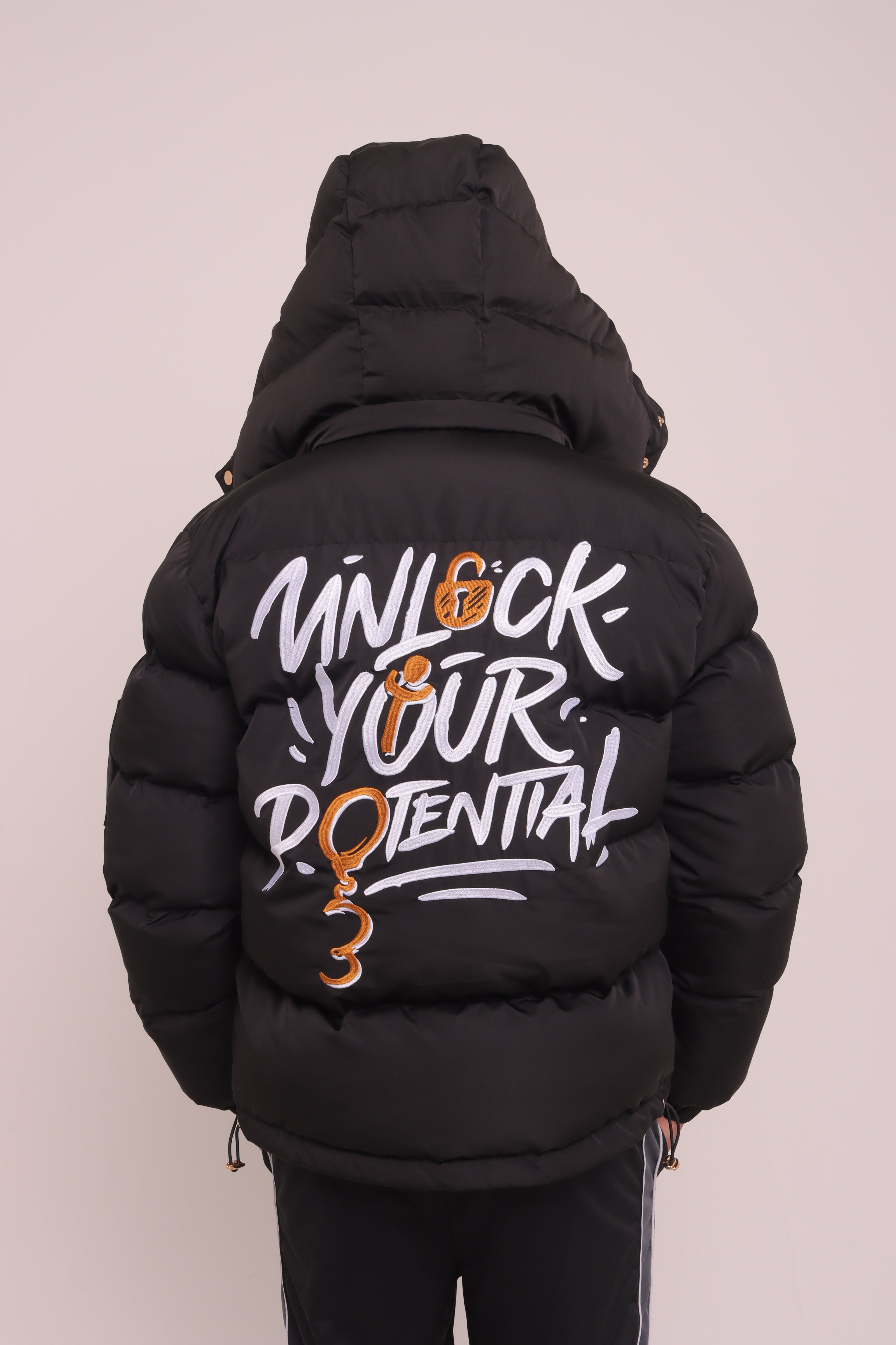 Black "Unlock Your Potential" Puffer Jacket