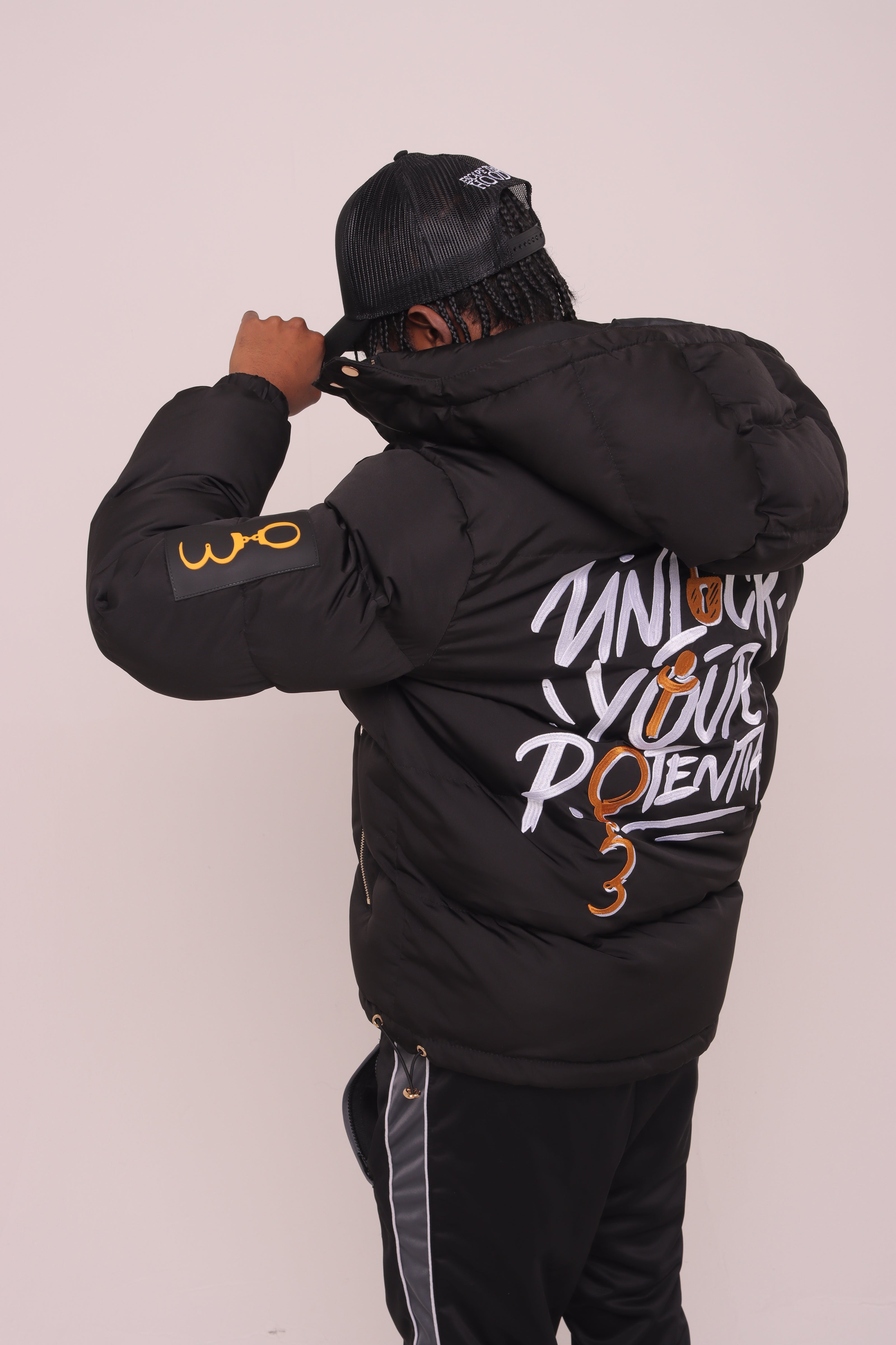 Black "Unlock Your Potential" Puffer Jacket